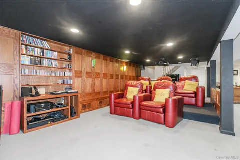 a living room with furniture a ceiling fan and a large window
