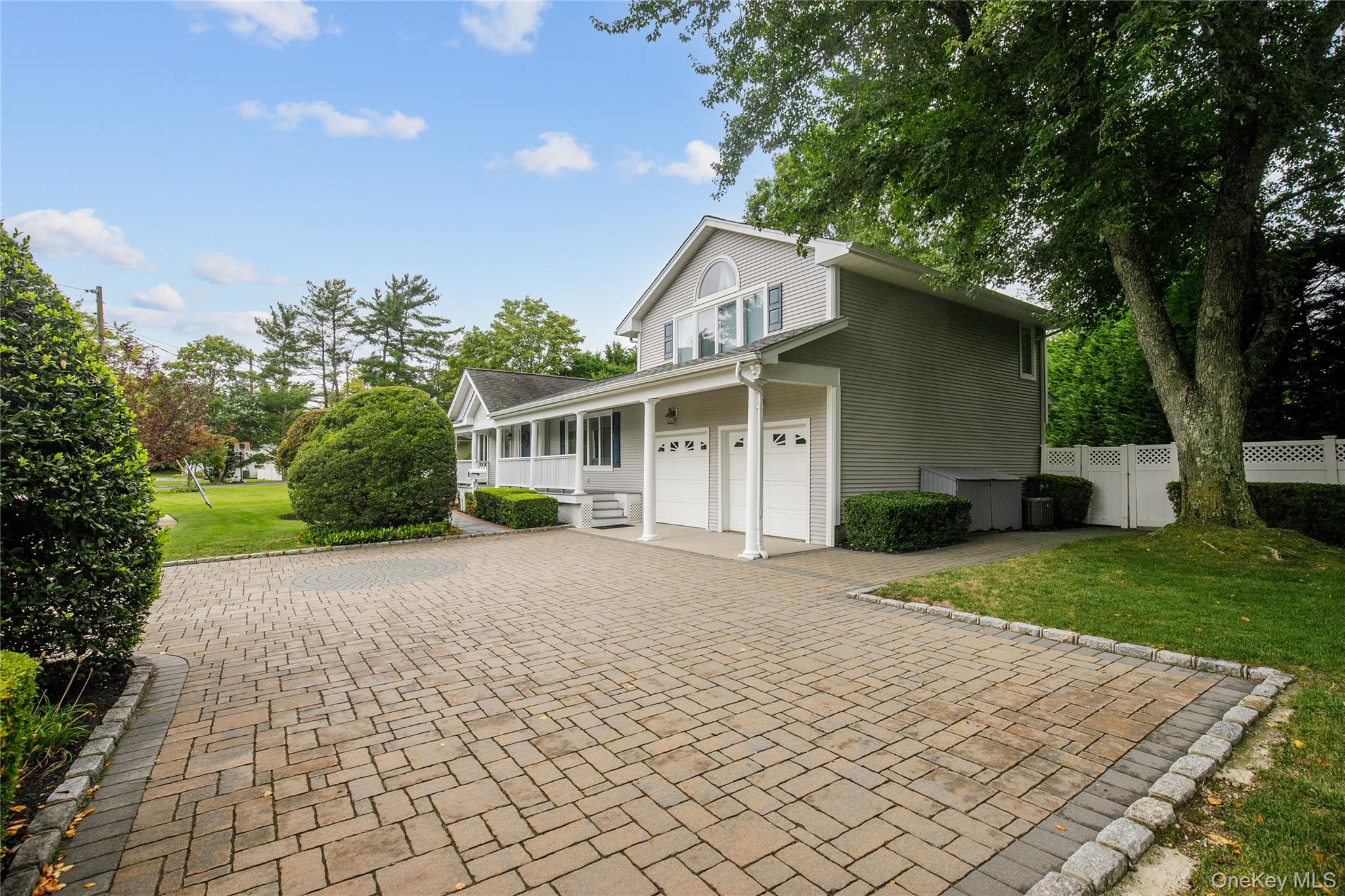 5 Searington Drive Syosset, NY 11791 - Photo 3 of 34 a front view of a house with a yard and a garage