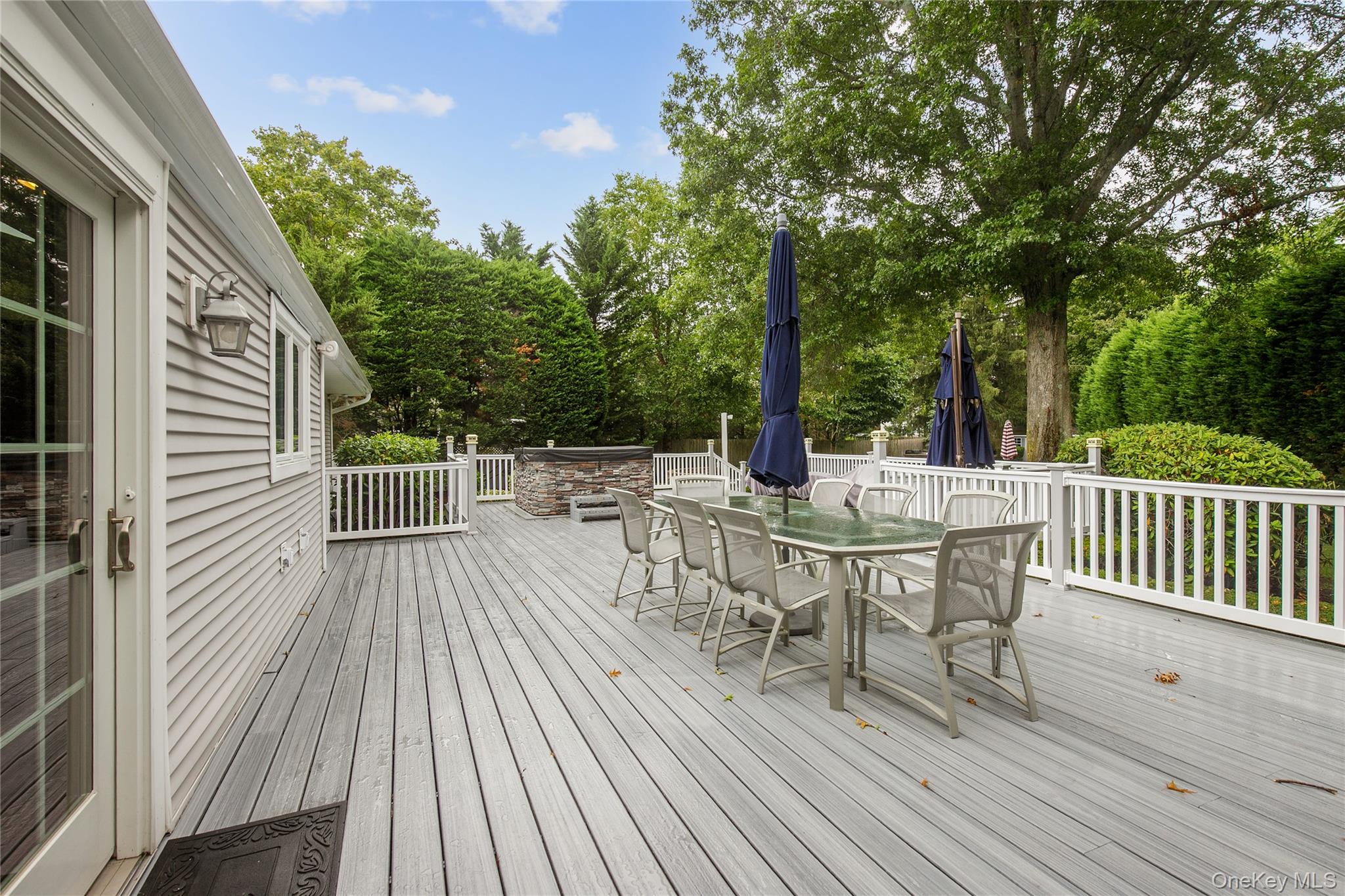 5 Searington Drive Syosset, NY 11791 - Photo 31 of 34 a view of a roof deck with table and chairs and wooden floor