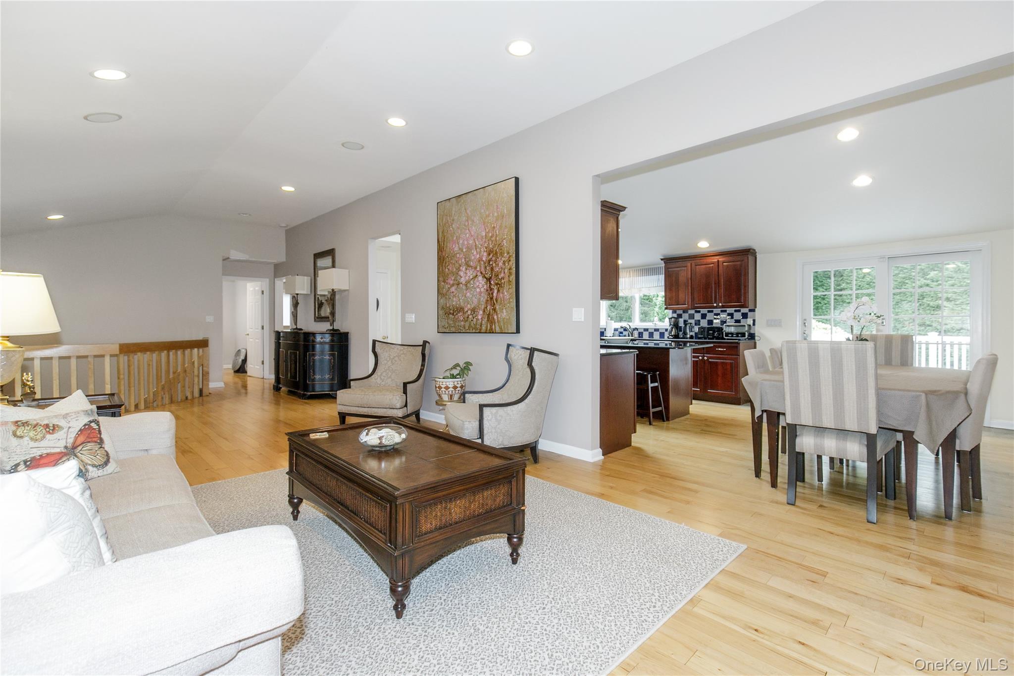 5 Searington Drive Syosset, NY 11791 - Photo 9 of 34 a living room with furniture a dining table and a flat screen tv