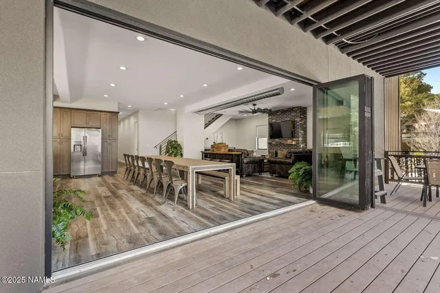 a view of a patio with table and chairs with wooden floor