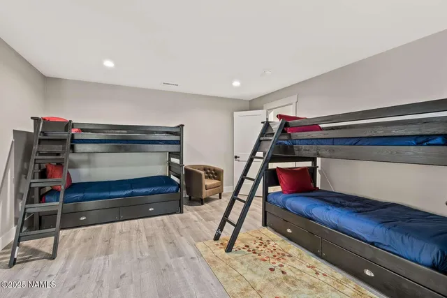 a room with furniture pool table and windows