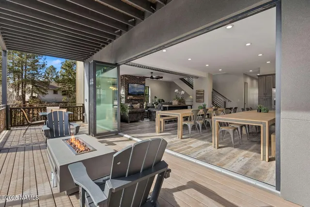 a dining room with furniture a rug a fireplace and a table