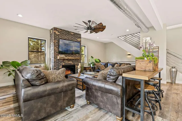 a living room with furniture a fireplace and a flat screen tv