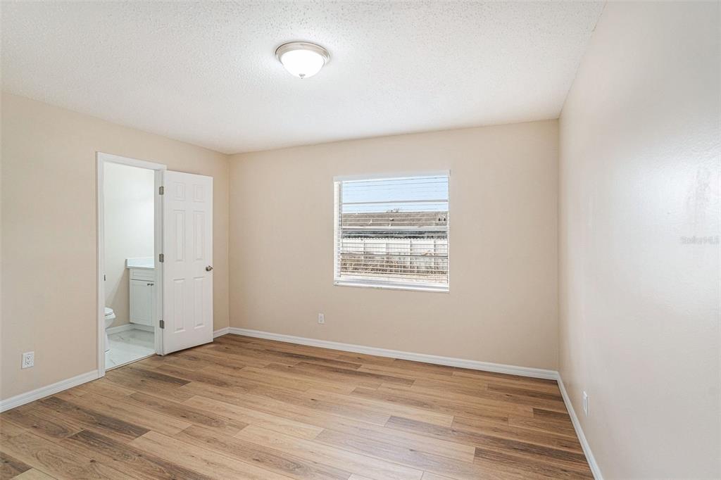 2527 Ridge Top Way Valrico, FL 33594 - Photo 12 of 29 a view of an empty room with wooden floor and a window
