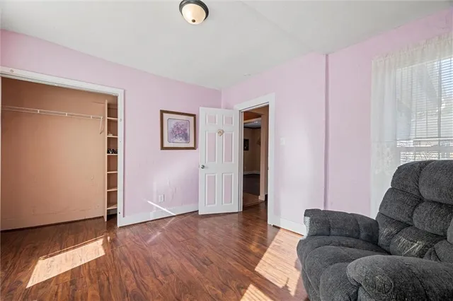 a living room with furniture and a hard wood floor