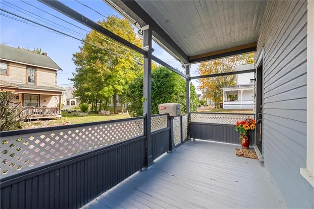 a view of a porch with wooden floor and furniture