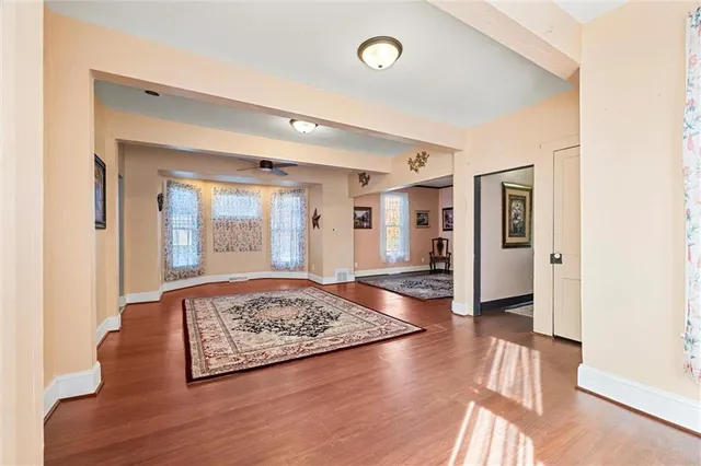 a view of a room with wooden floor and furniture