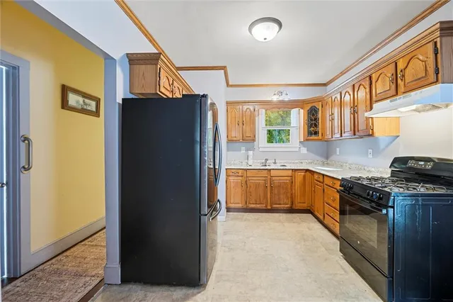 a kitchen with stainless steel appliances granite countertop a refrigerator and a sink