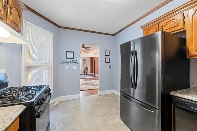 a kitchen with stainless steel appliances granite countertop a refrigerator and a stove