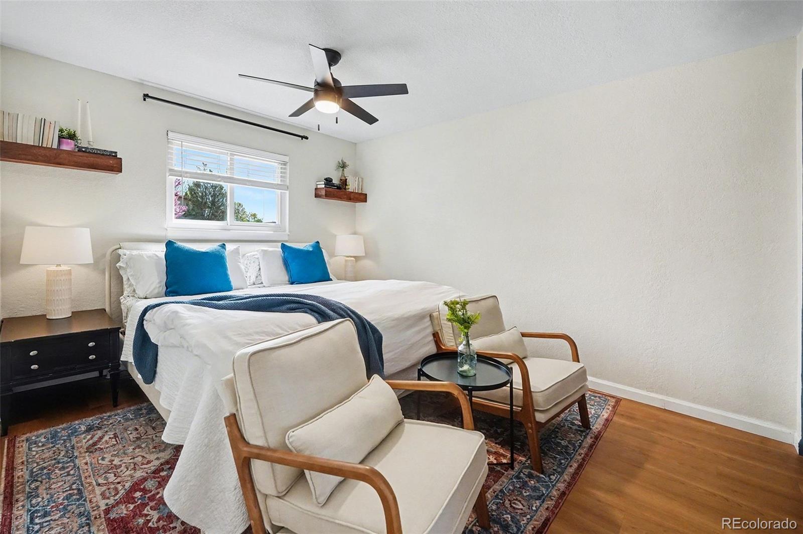 8207 High Street Denver, CO 80229 - Photo 11 of 31 a bedroom with a bed and wooden floor