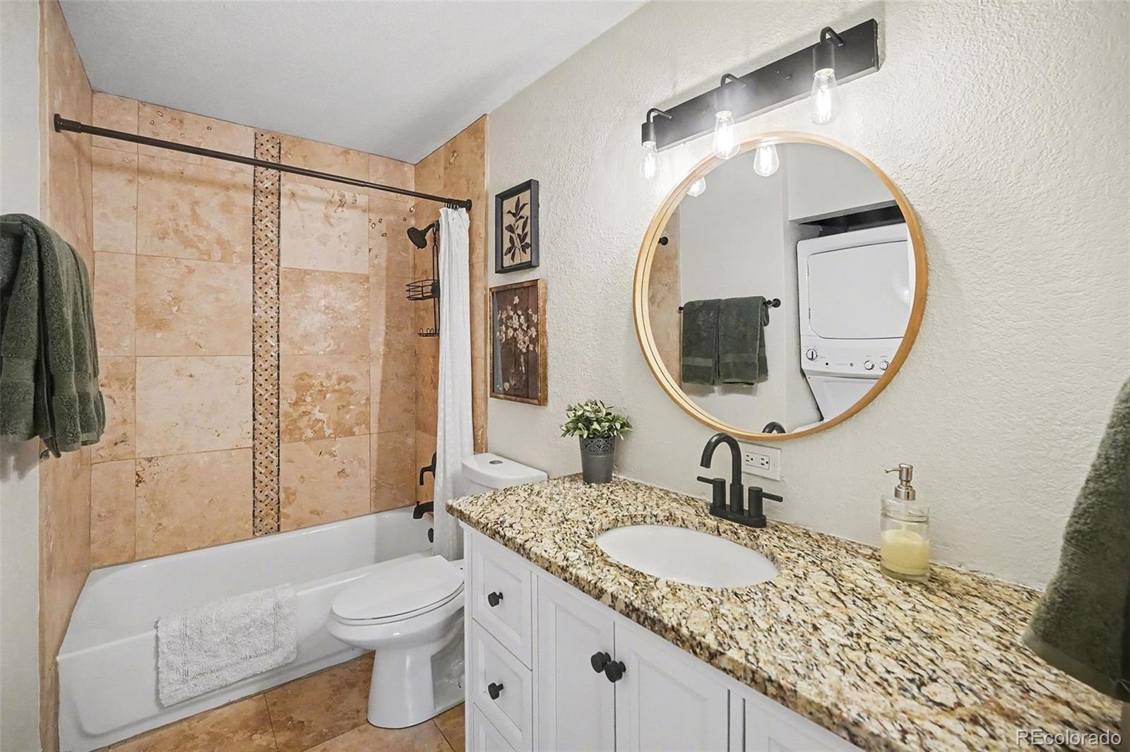 8207 High Street Denver, CO 80229 - Photo 12 of 31 a bathroom with a granite countertop sink and a mirror