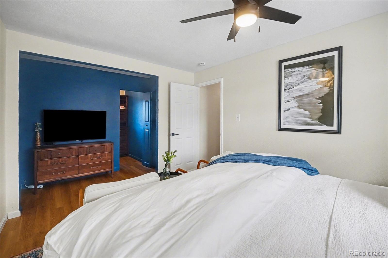 8207 High Street Denver, CO 80229 - Photo 13 of 31 a bedroom with a bed and wooden floor