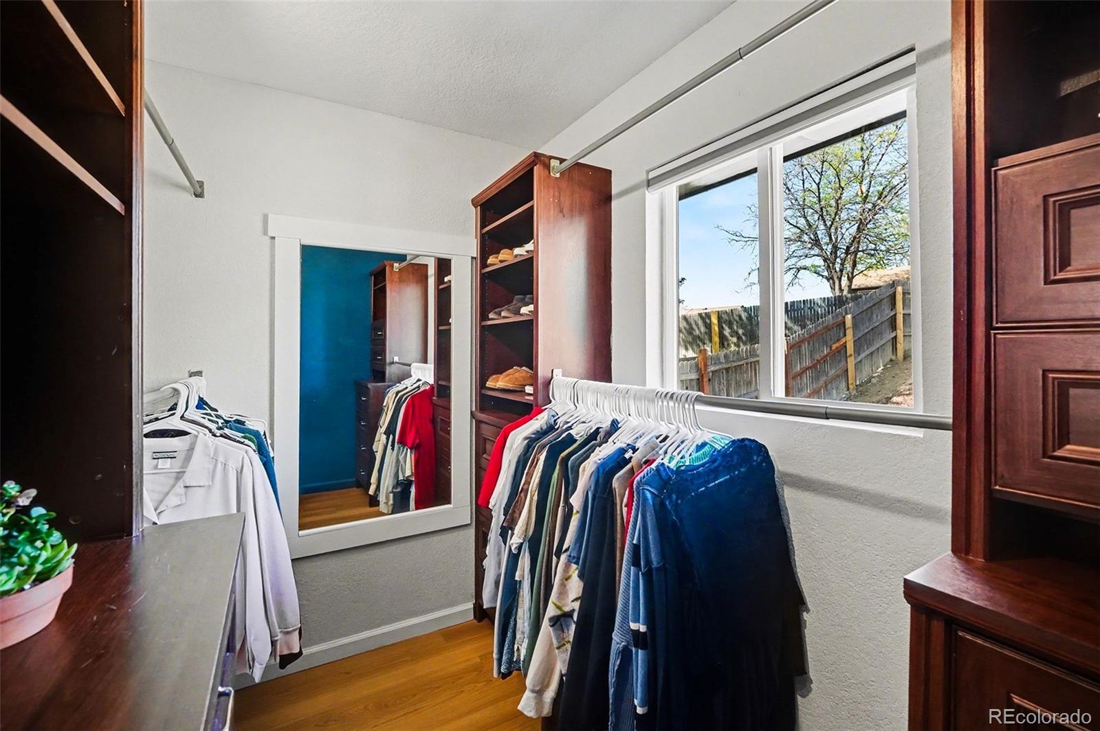 8207 High Street Denver, CO 80229 - Photo 14 of 31 a view of walk in closet with clothes and shoes