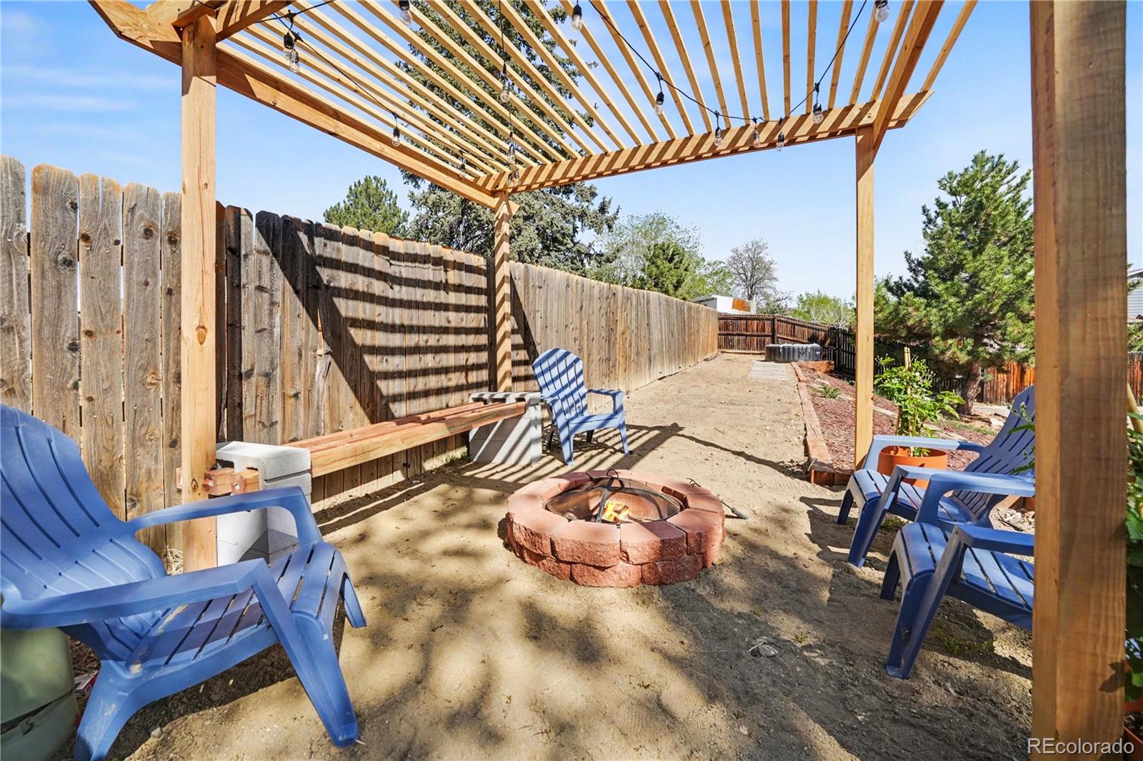 8207 High Street Denver, CO 80229 - Photo 19 of 31 a backyard of a house with table and chairs