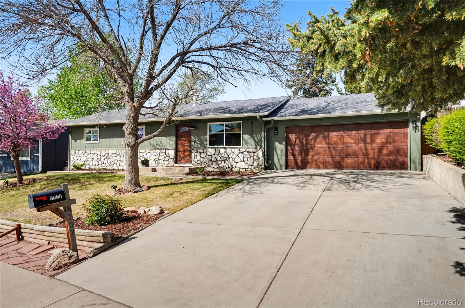 8207 High Street Denver, CO 80229 - Photo 3 of 31 a front view of a house with garden and porch