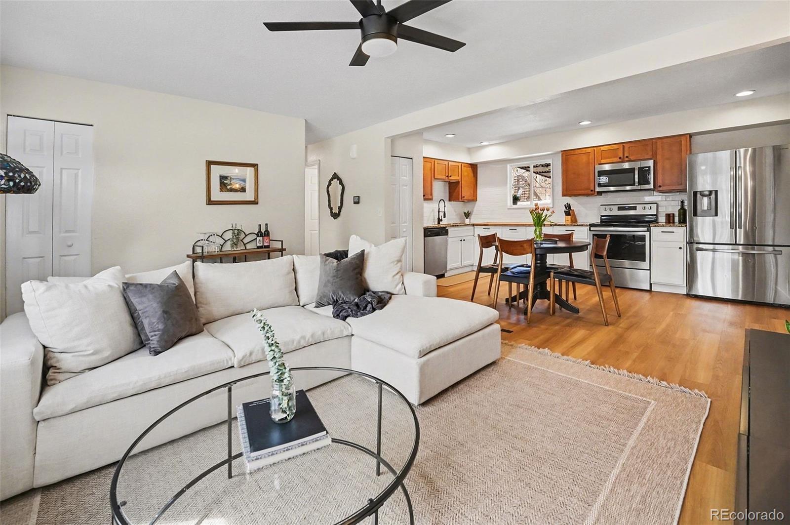 8207 High Street Denver, CO 80229 - Photo 4 of 31 a living room with furniture kitchen view and a window