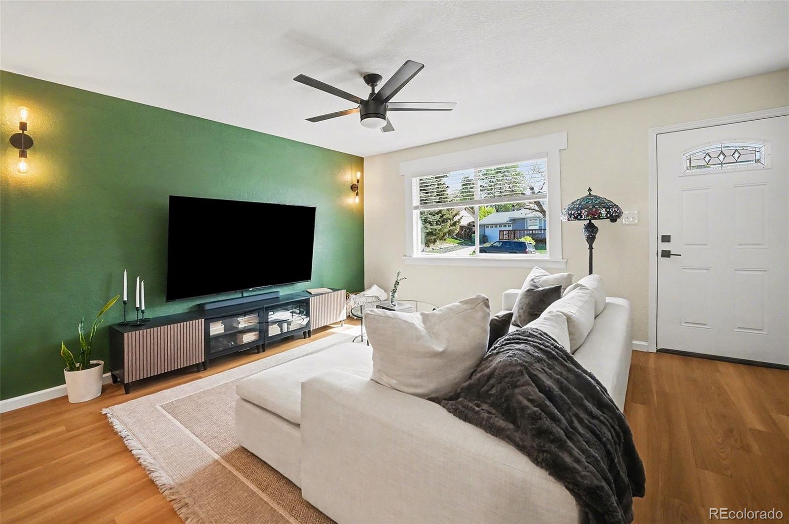 8207 High Street Denver, CO 80229 - Photo 5 of 31 a living room with furniture and a flat screen tv