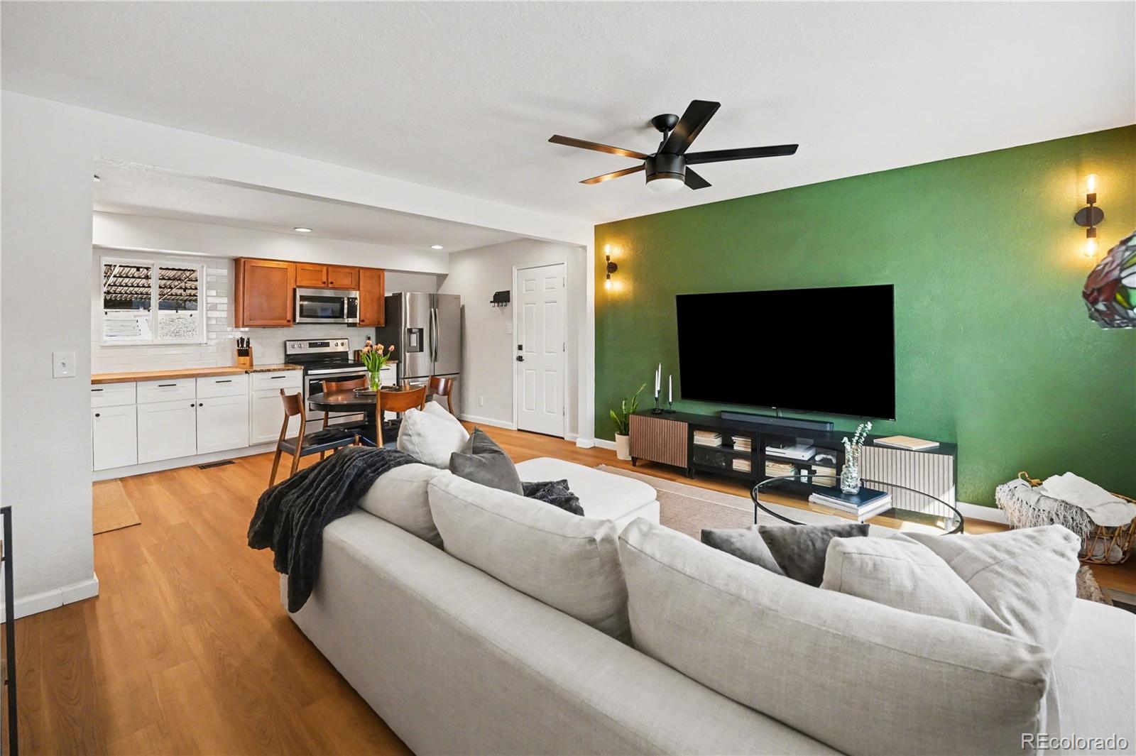 8207 High Street Denver, CO 80229 - Photo 6 of 31 a living room with furniture and a flat screen tv