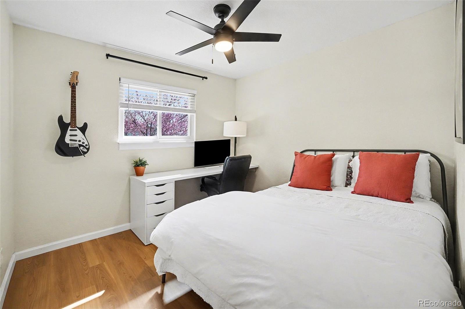 8207 High Street Denver, CO 80229 - Photo 10 of 31 a bedroom with a bed and a desk