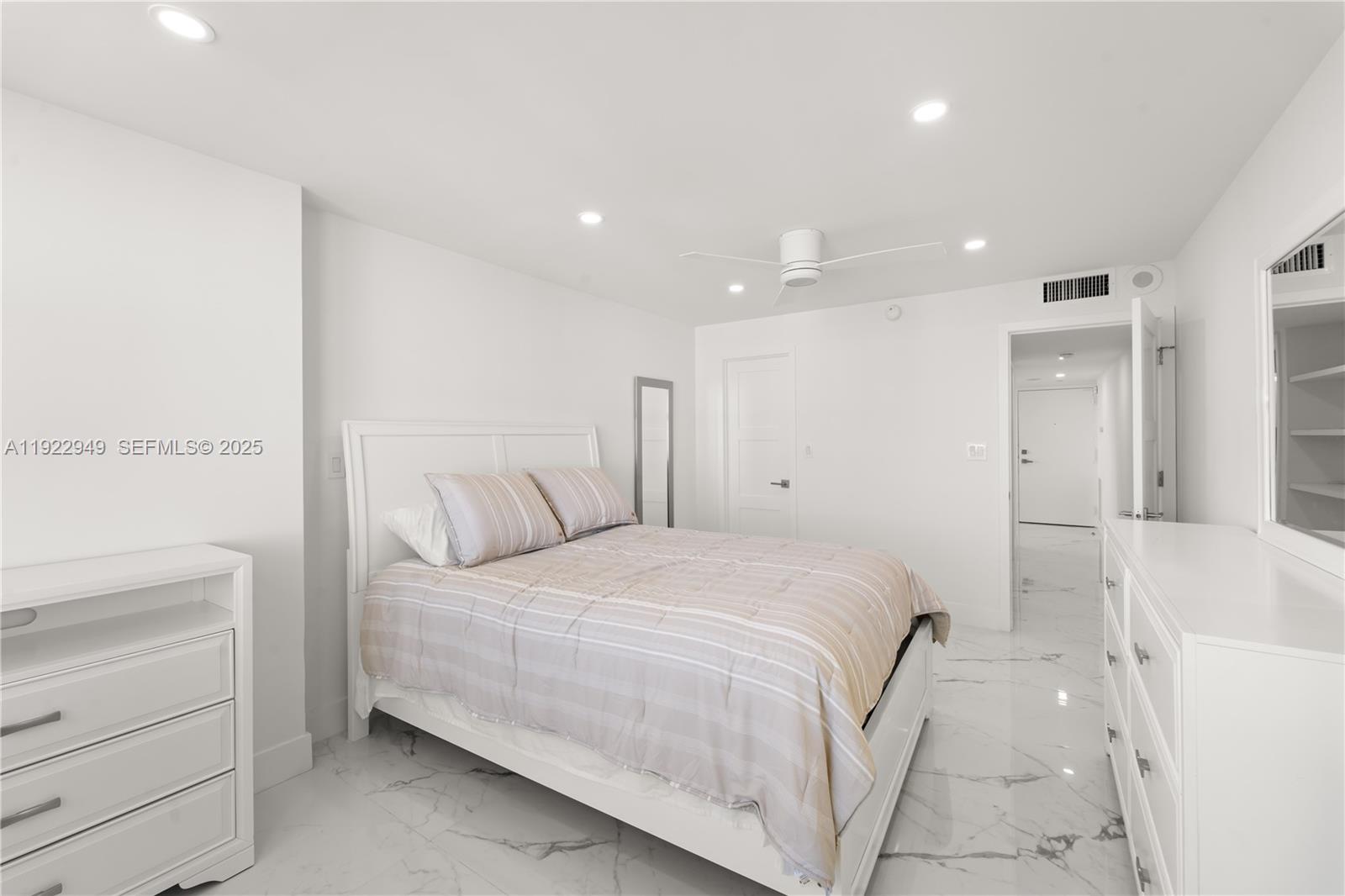 2801 Northeast 183rd Street, Unit 2116W Aventura, FL 33160 - Photo 15 of 23 a bedroom with a bed and a vanity