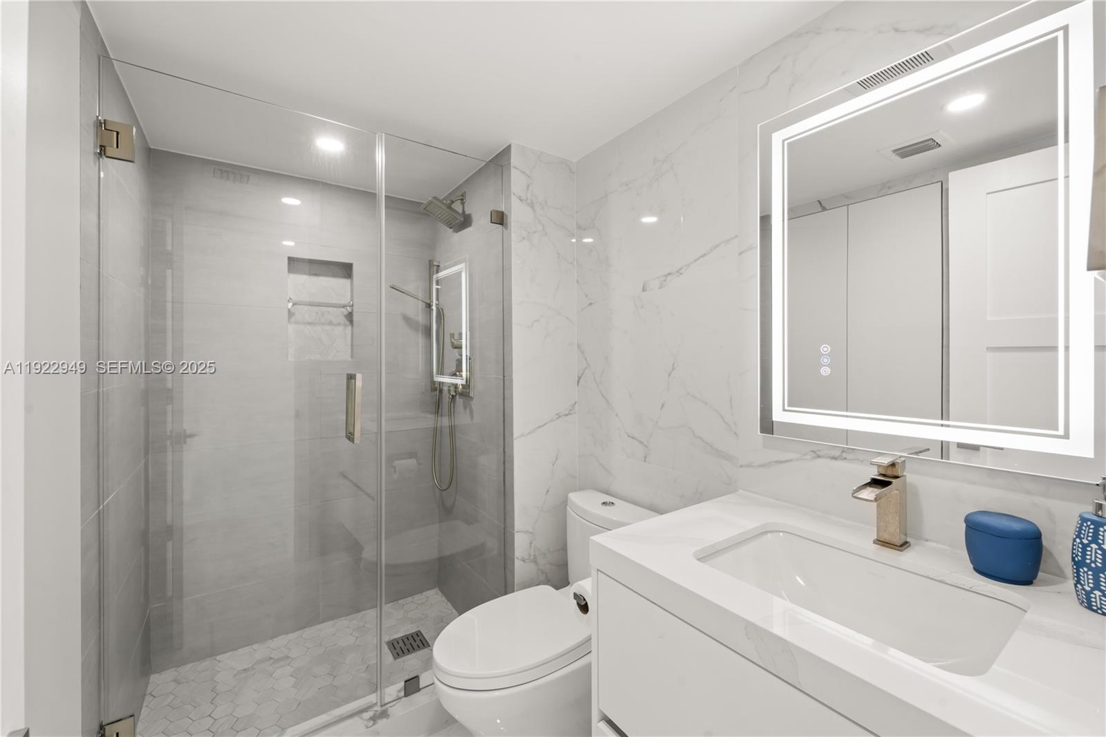 2801 Northeast 183rd Street, Unit 2116W Aventura, FL 33160 - Photo 16 of 23 a bathroom with a sink a toilet and shower