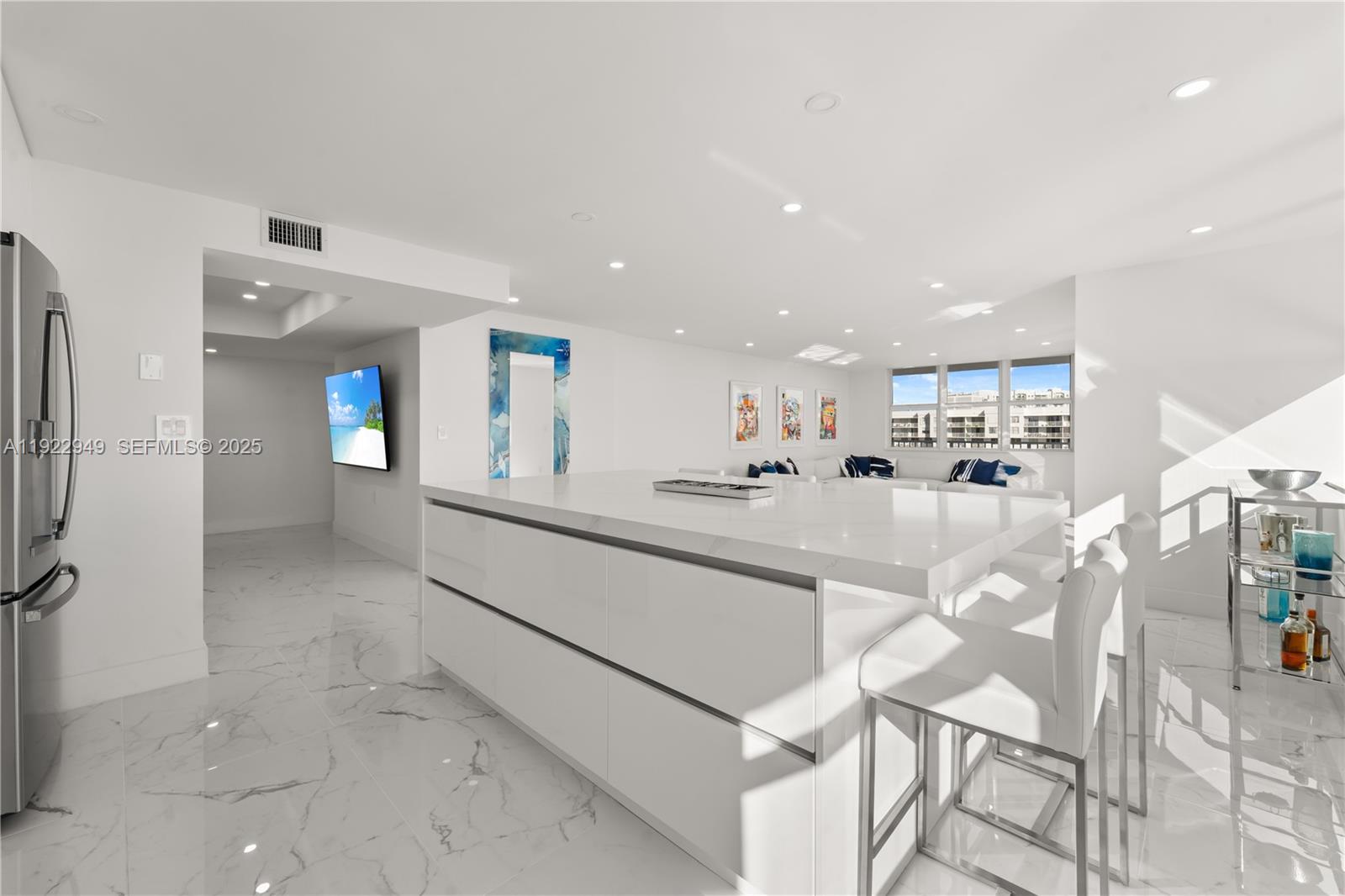 2801 Northeast 183rd Street, Unit 2116W Aventura, FL 33160 - Photo 5 of 23 a view of a living room and kitchen with stainless steel appliances