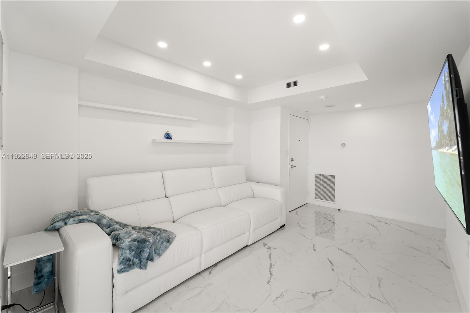 2801 Northeast 183rd Street, Unit 2116W Aventura, FL 33160 - Photo 7 of 23 a living room with furniture and a table