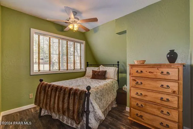 a bedroom with a bed and a dresser