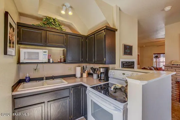 a kitchen with granite countertop a sink and cabinets