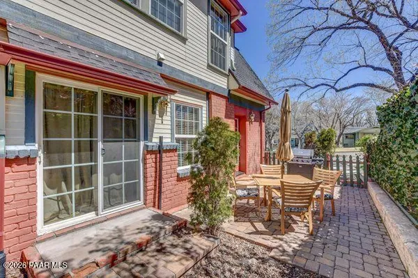 a view of a house with a large window and plants