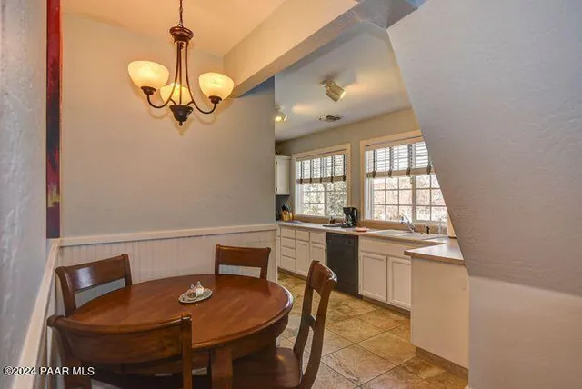 a view of a dining room with furniture wooden floor and chandelier