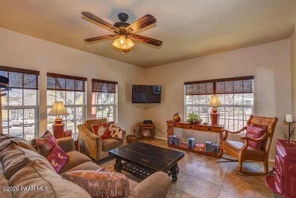 a living room with furniture a chandelier and a large window
