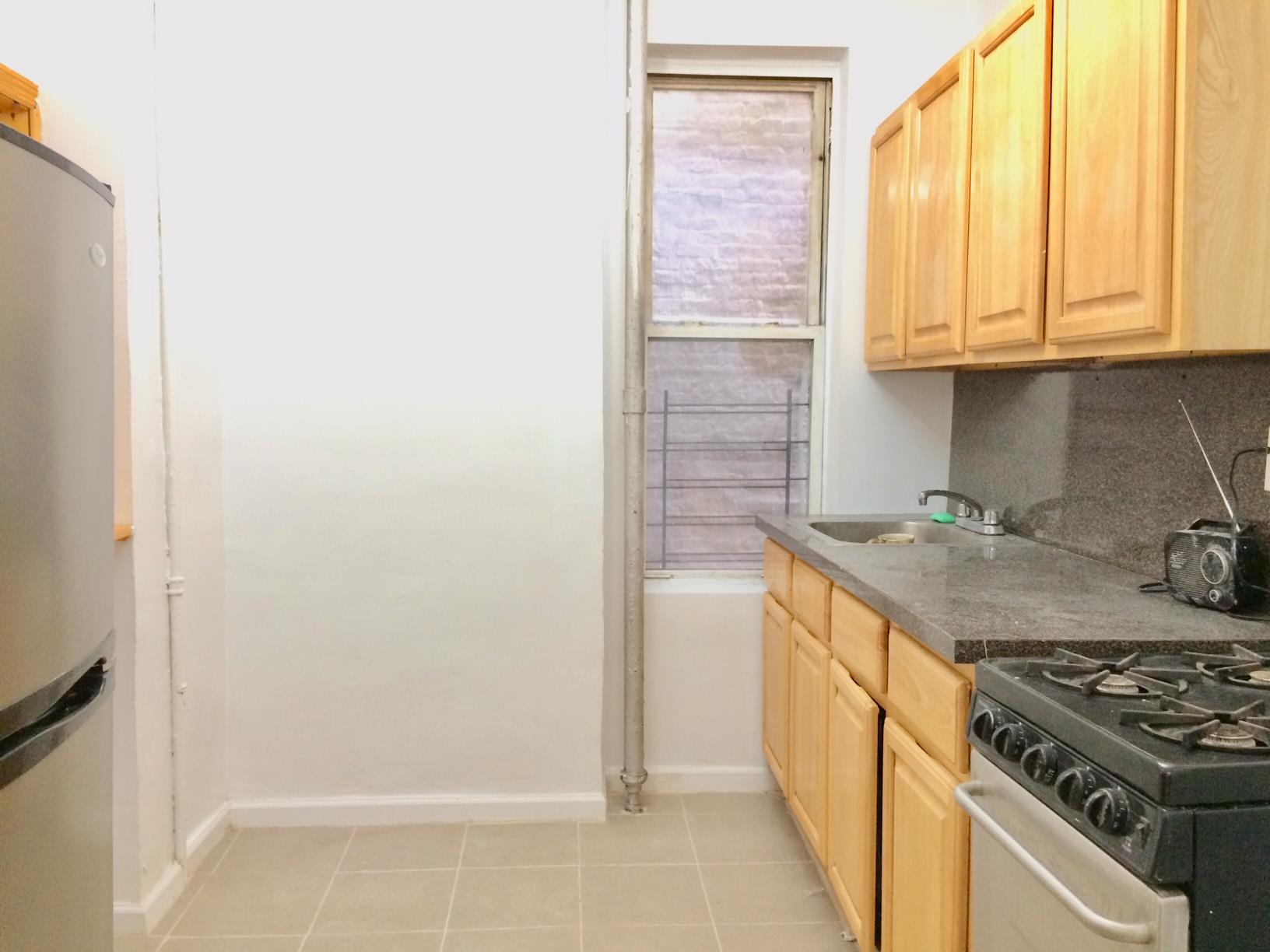 a kitchen with stainless steel appliances granite countertop a stove and a refrigerator