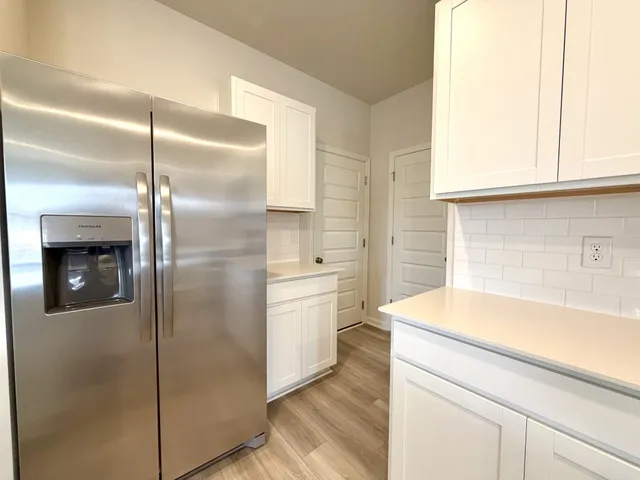 a kitchen with a refrigerator and a sink