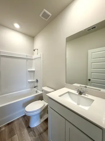 a bathroom with a sink a toilet and a bathtub