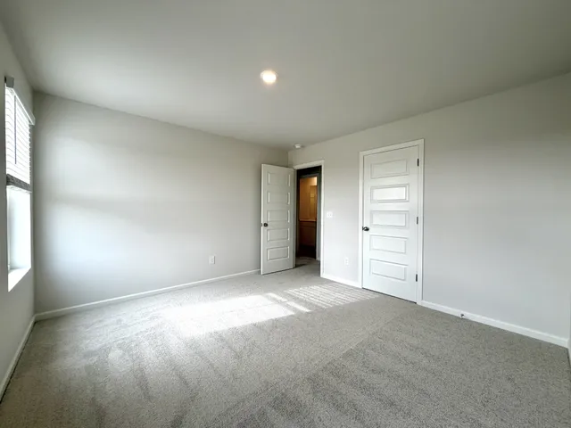 an empty room with windows and closet