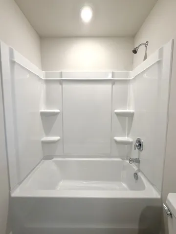 a bathroom with a shower and a bath tub