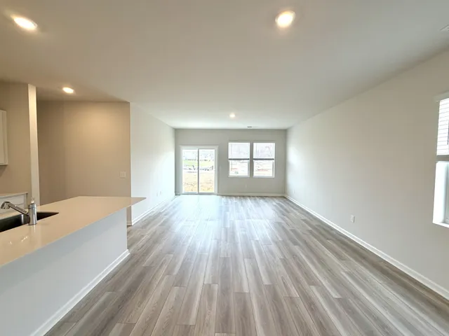 a view of a room with wooden floor and windows