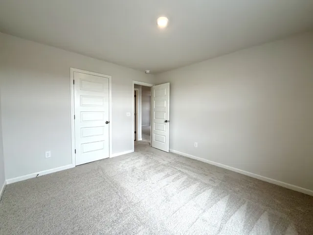 a view of an empty room and chandelier