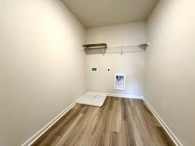 a view of a room with wooden floor