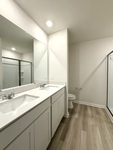 a bathroom with a glass shower door