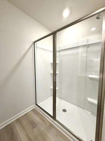 a bathroom with a glass shower door