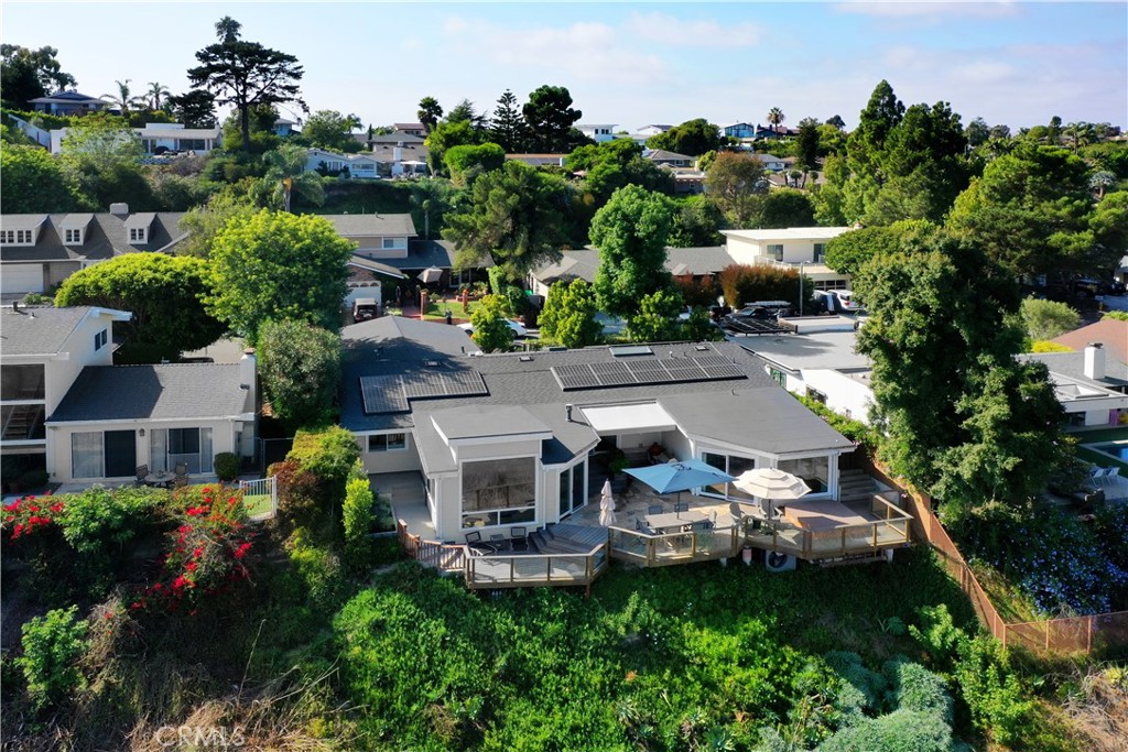 an aerial view of a house with yard swimming pool and outdoor seating