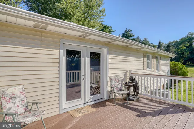 a view of a deck with wooden floor and fence