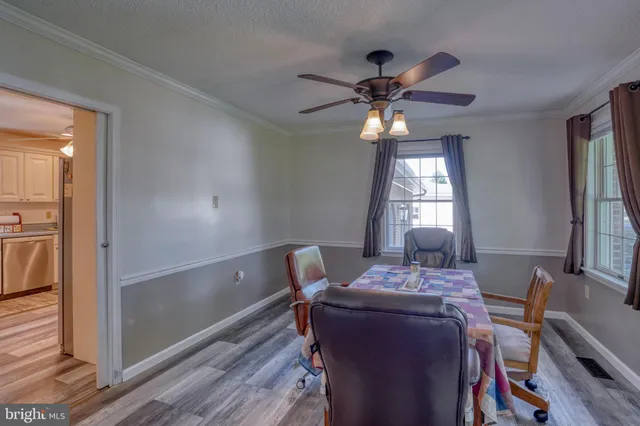 a view of a dining room with furniture and window