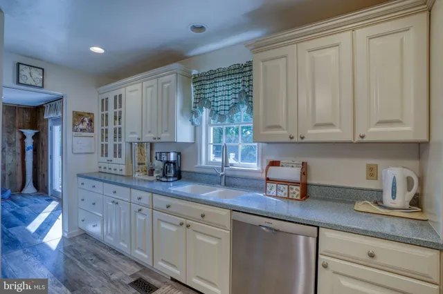 a kitchen with sink cabinets and window