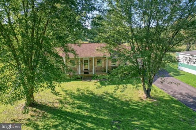 a view of house with yard