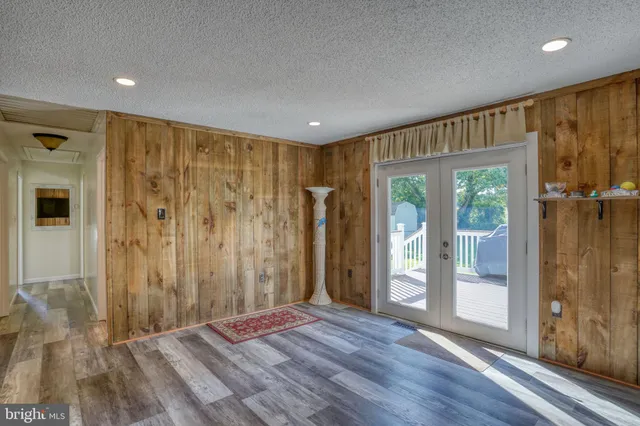 a view of a room with wooden floor and windows