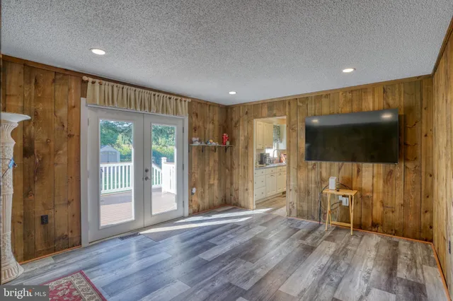 a view of a livingroom with wooden floor and a flat screen tv